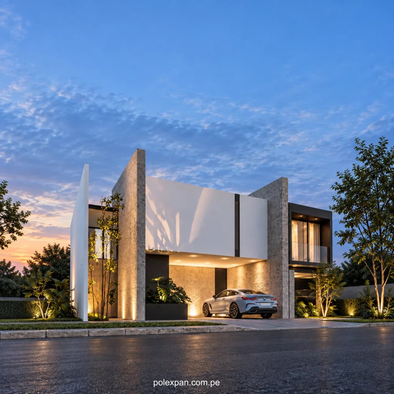 Vivienda moderna de dos plantas iluminada al anochecer, con un coche en la entrada.