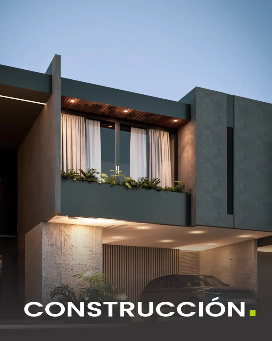 Fachada de una vivienda moderna al anochecer con paneles de aislamiento en el volumen superior.